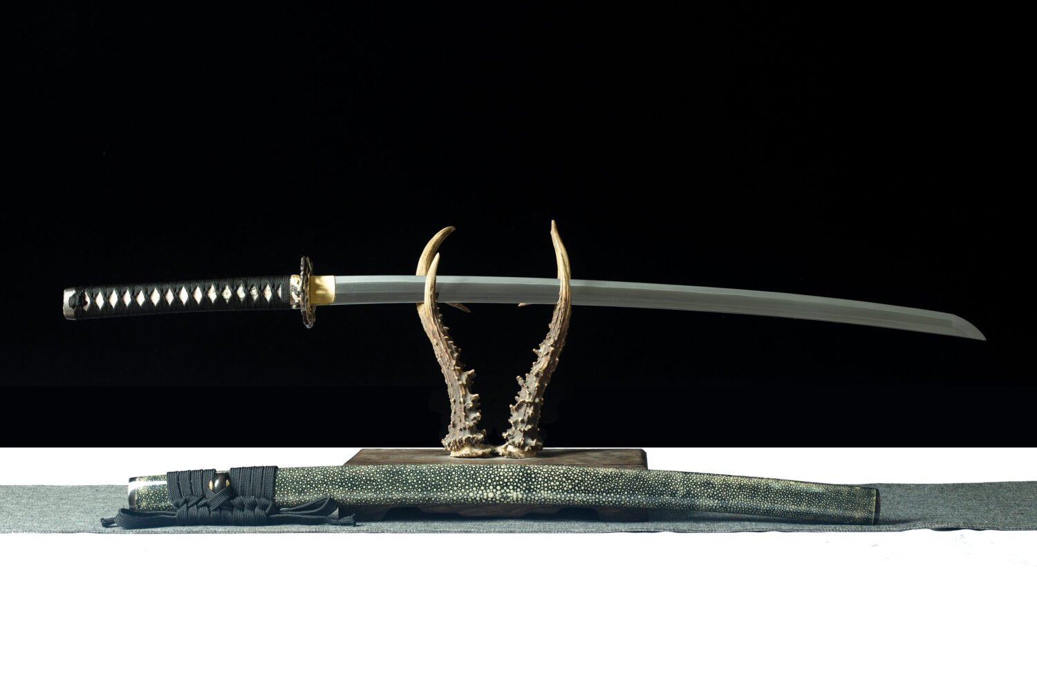 Elegant Japanese sword with a sharp blade and intricately detailed handle.